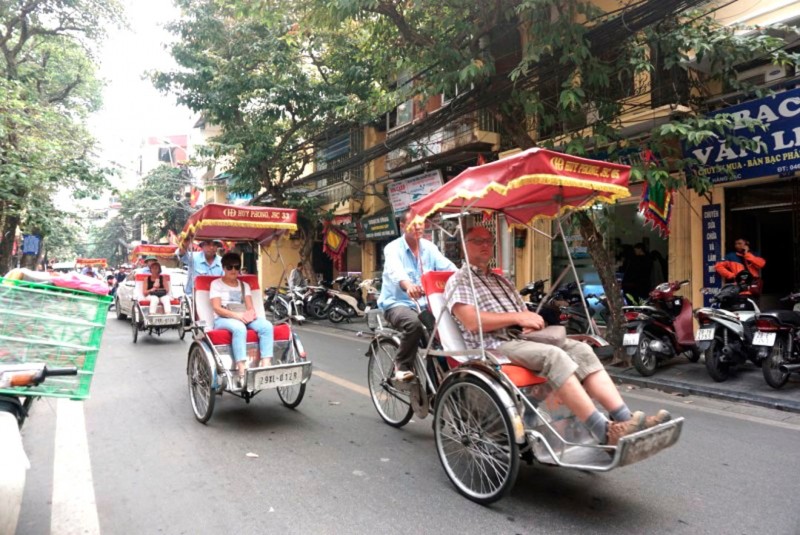 An exciting cyclo tour through the Hanoi Old Quarter where travelers can comb through the stalls of local markets selling handmade goods to end the day. (Cyclo in Vietnam)